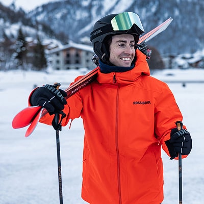 A man with his skis on the shoulder